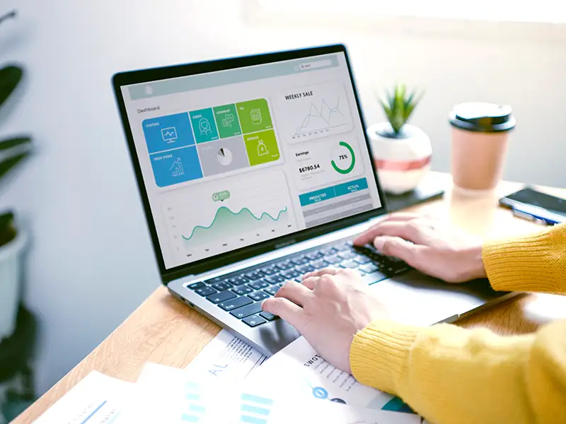 small business owner using crm dashboard on laptop